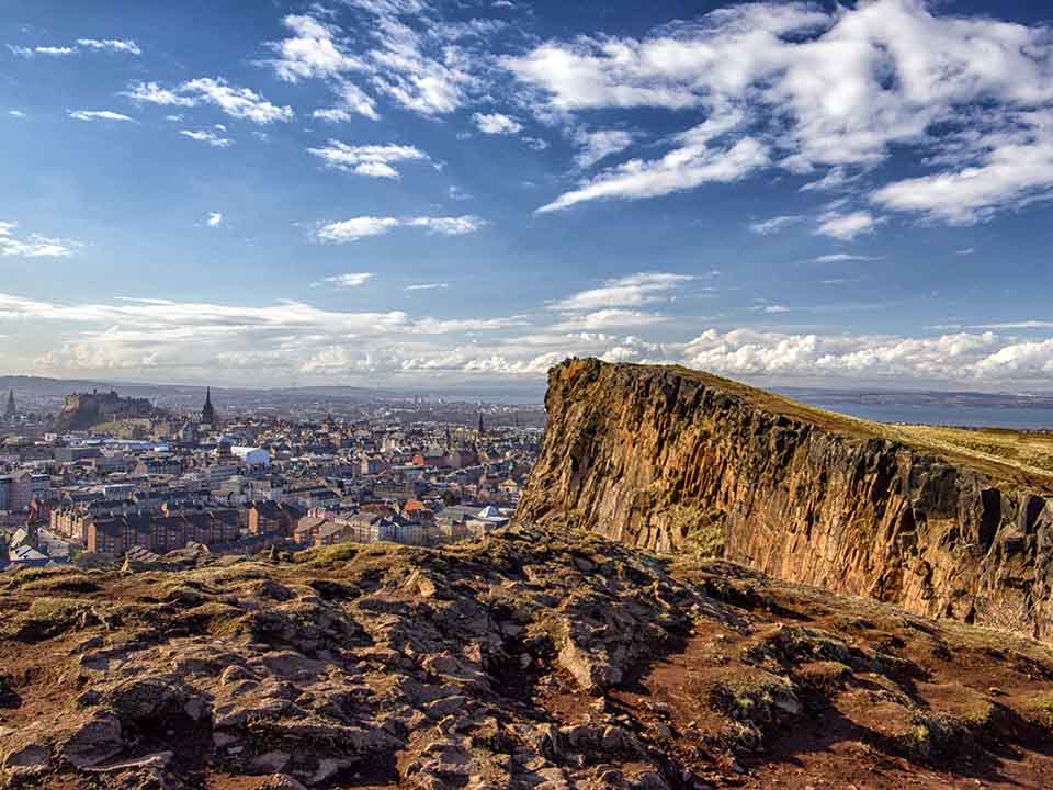 Arthur's Seat overlooking Edinburgh city skyline on a clear day