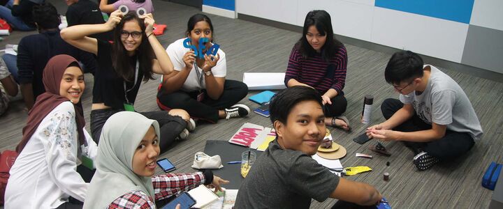 Group of students sitting on the floor engaged in a group activity