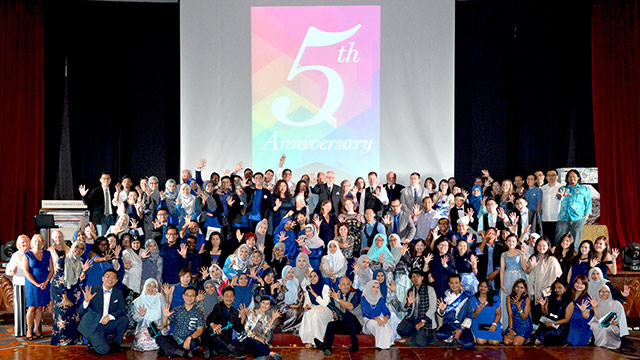 group shot of students celebrating the fifth anniversary