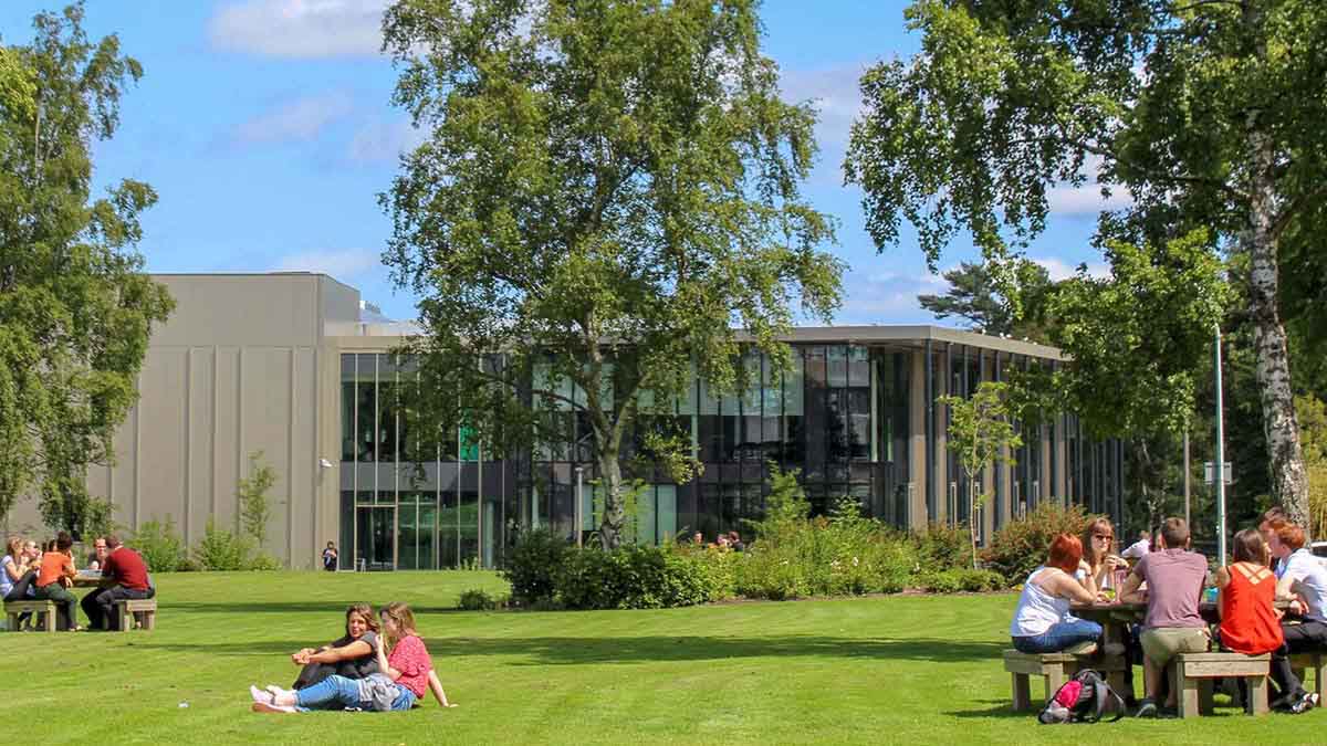 Students lunching on the grass in front of the GRID building, Edinburgh Campus