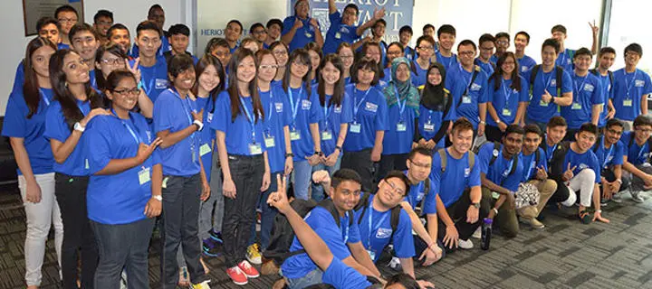 Group shot of Heriot-Watt Malaysia's first batch of staff and students wearing matching blue tshirts