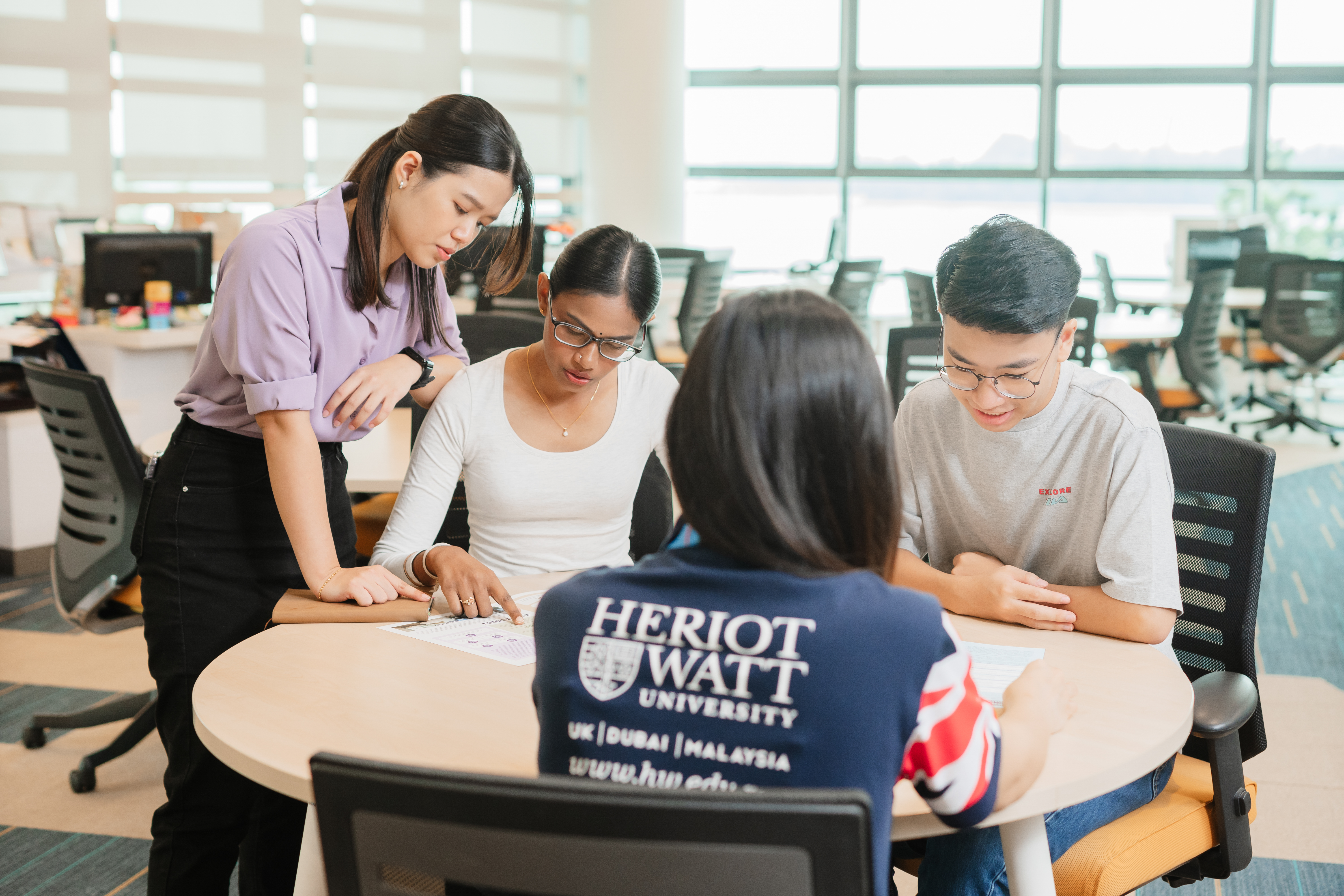 A group of students looking at the printed publication