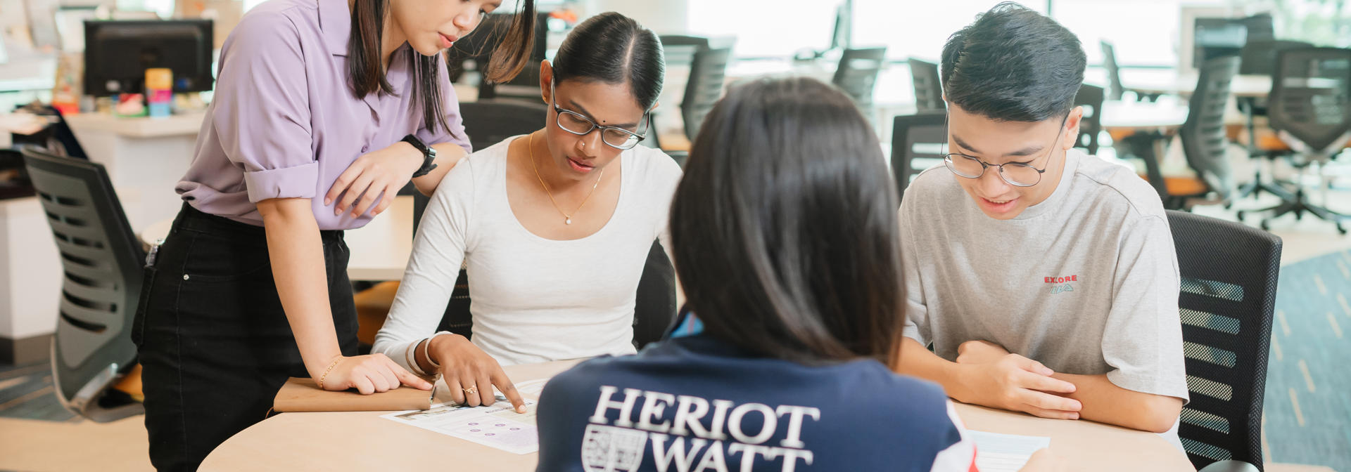 A group of students looking at the printed publication