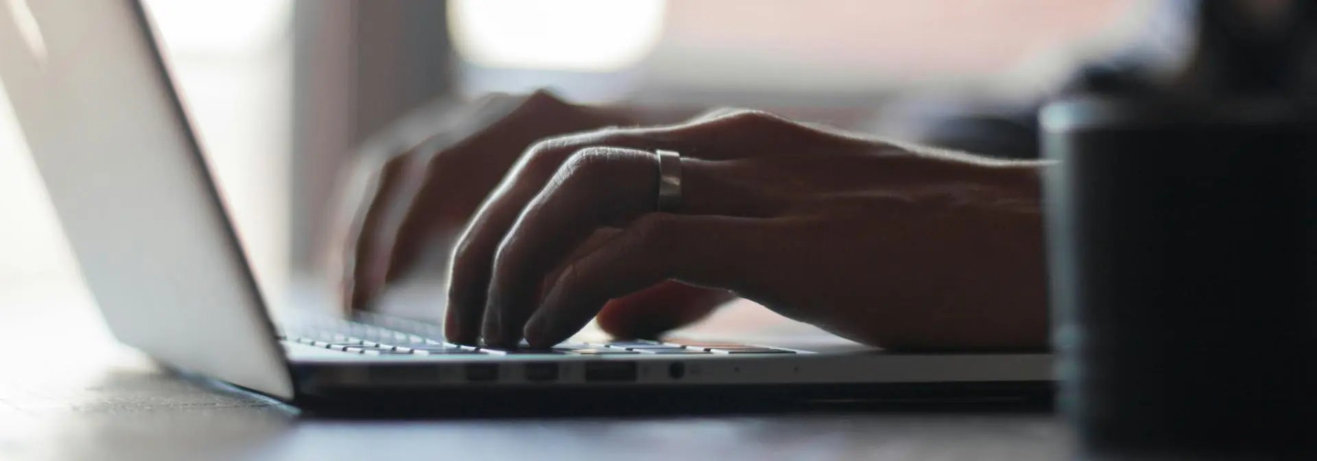 Close up of a person typing on a laptop