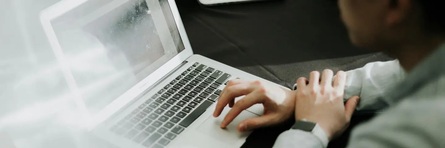 A student looking at the laptop screen