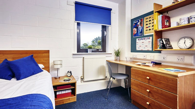 Bedroom showing bed, window and desk