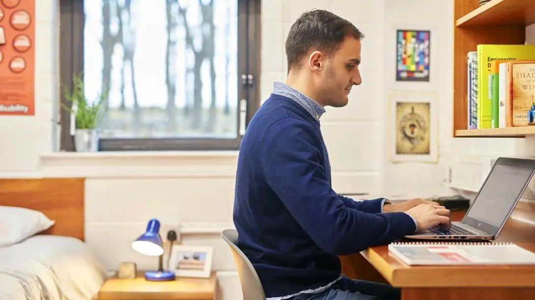 Student using laptop at desk