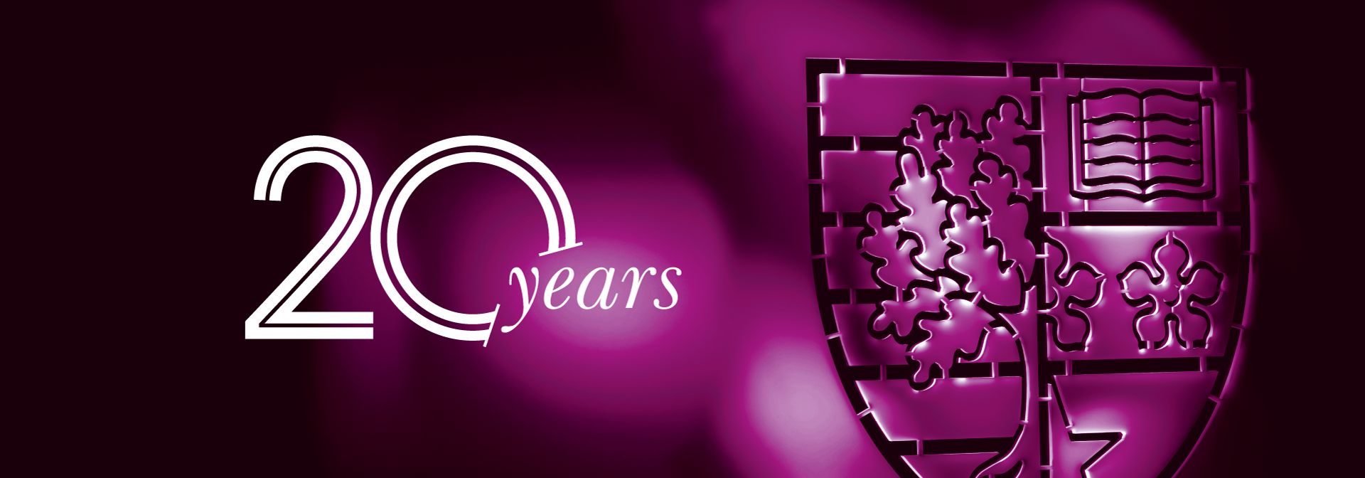20 years logo on a dark purple background and metallic shield
