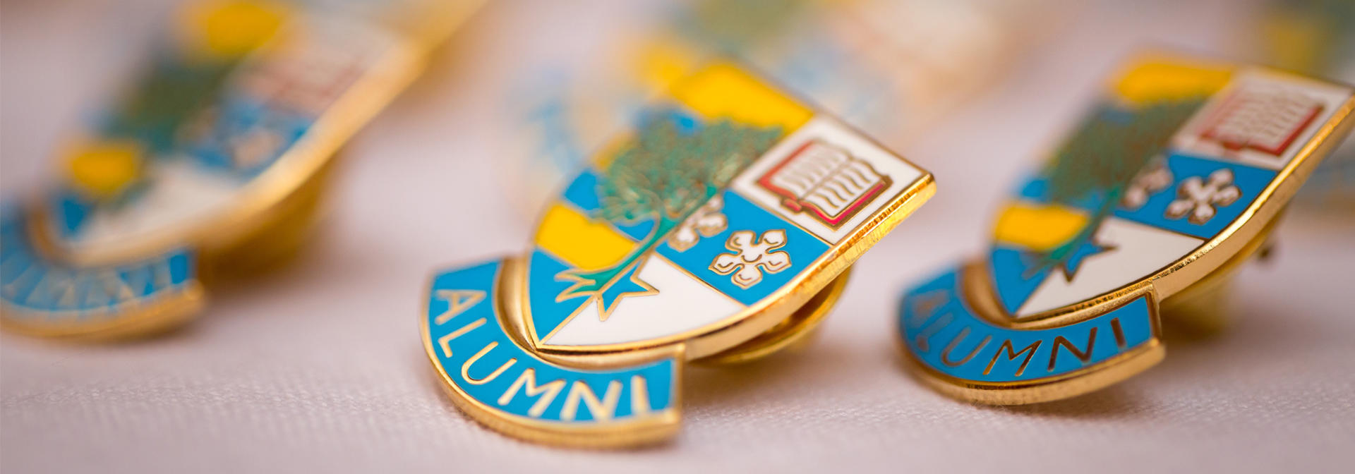 Heriot-Watt Alumni badges on a white cloth