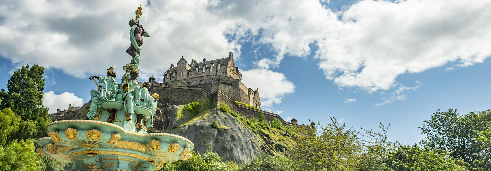 The Ross Fountain with Edinburgh Castle and a blue sky in the background.
