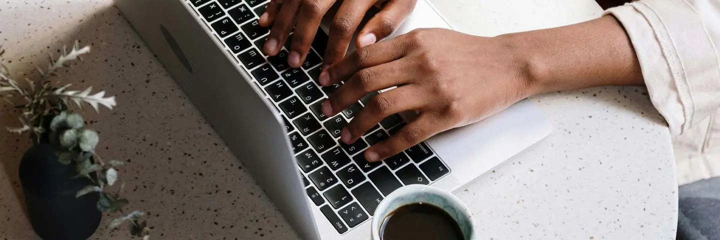 Person typing on a laptop.