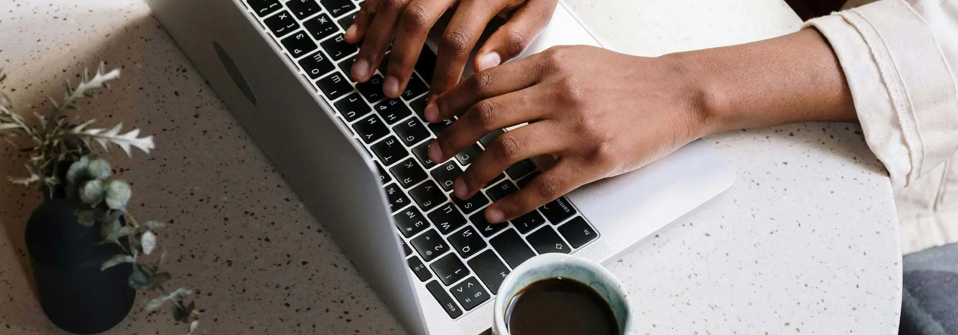 Person typing on a laptop.