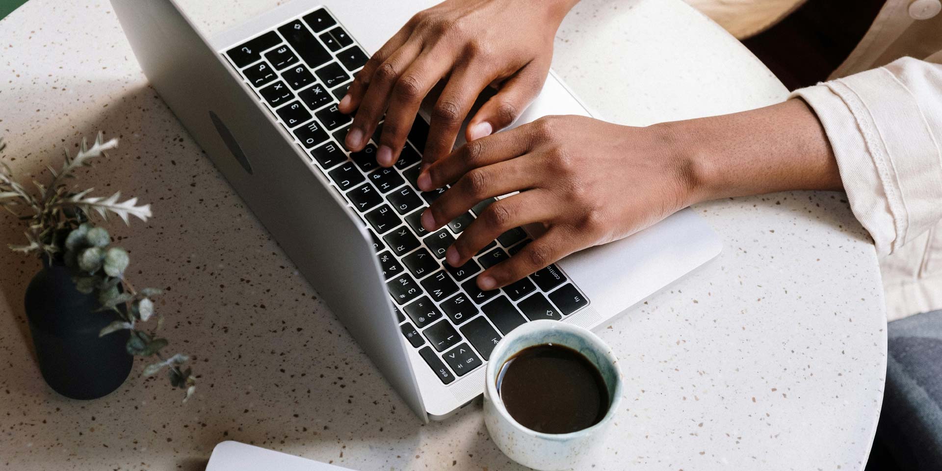 Person typing on a laptop.