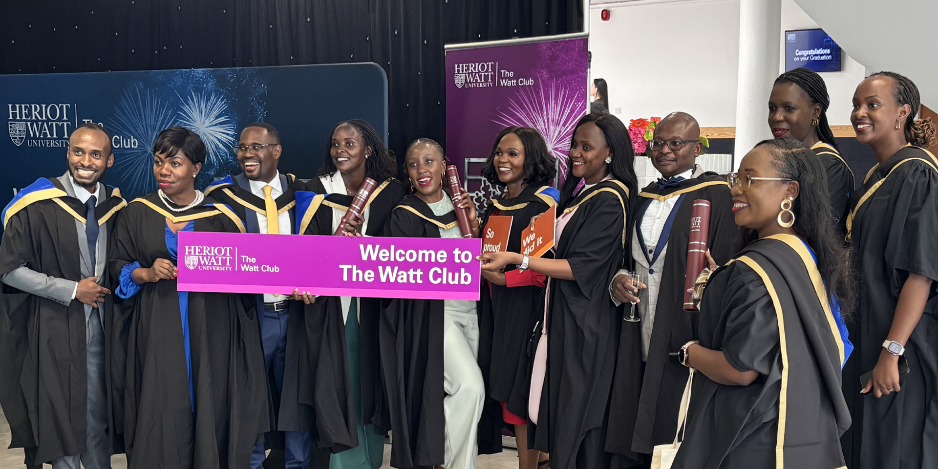 Heriot-Watt graduates pose for a picture in their gowns.