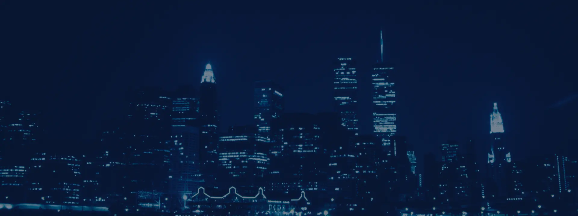 Blue skyscraper skyline at night.