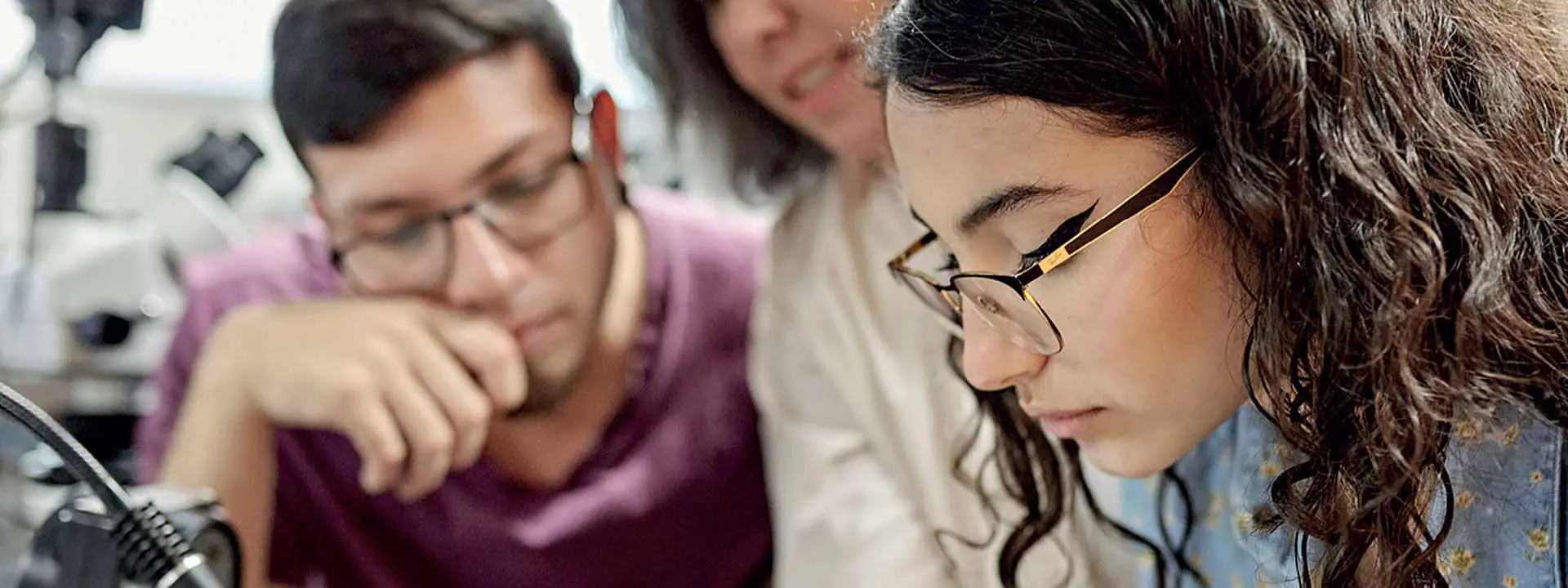 Three individuals focusing on a task