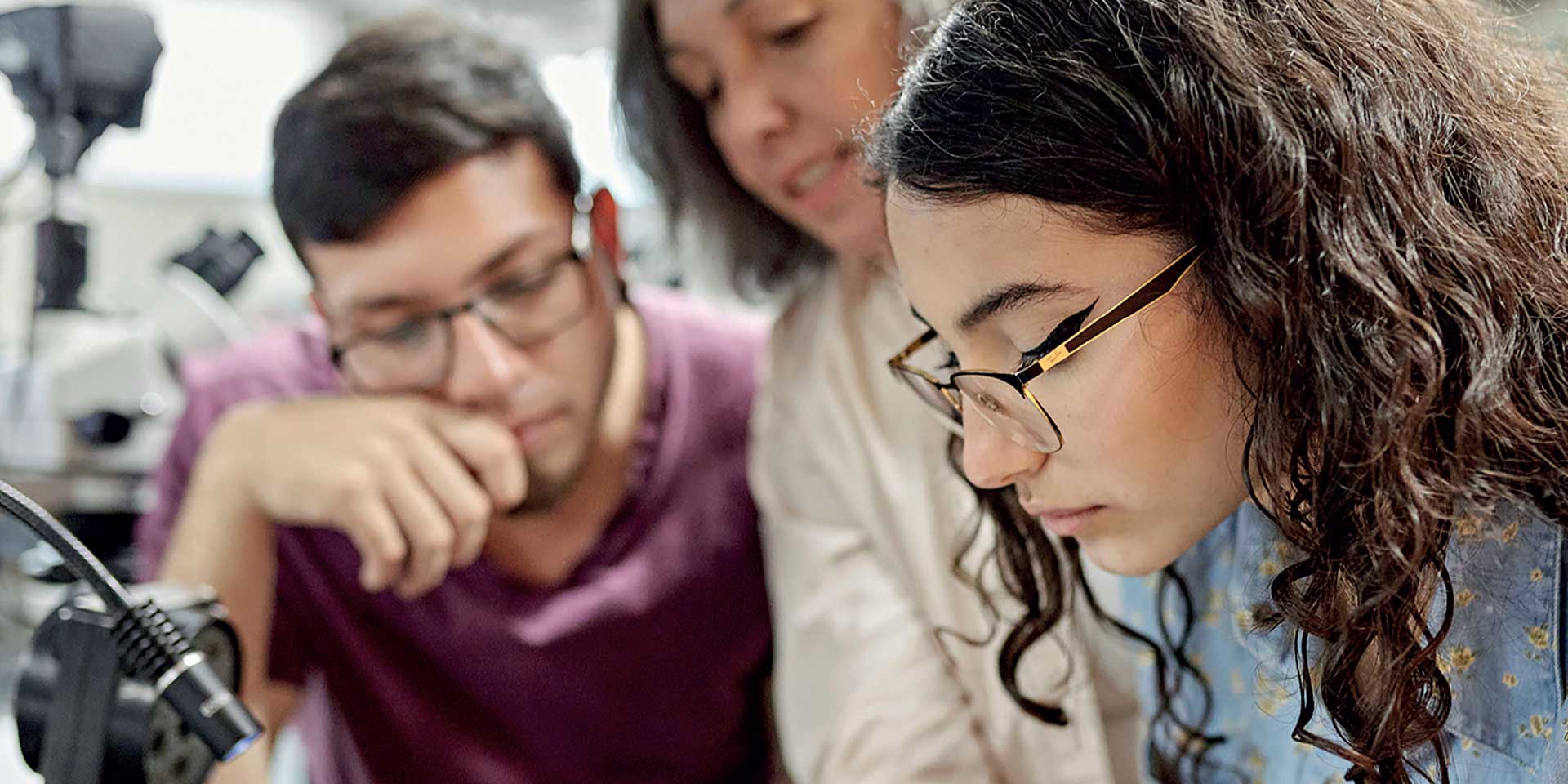 Three individuals focusing on a task 