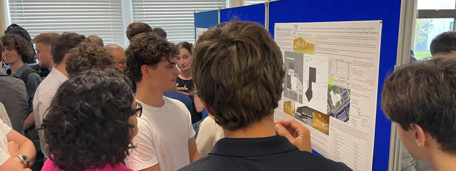 Students gathered round a poster