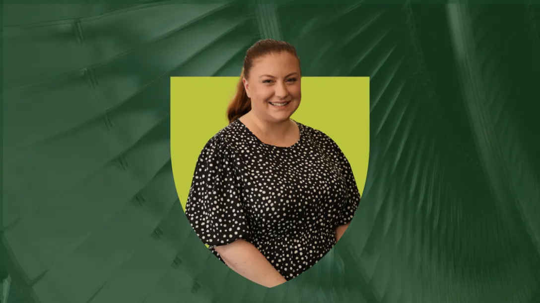 Mhairi Bruce, Enrolment Advisor at Heriot-Watt Online, smiles at camera. She appears in a green shield on a darker green background.