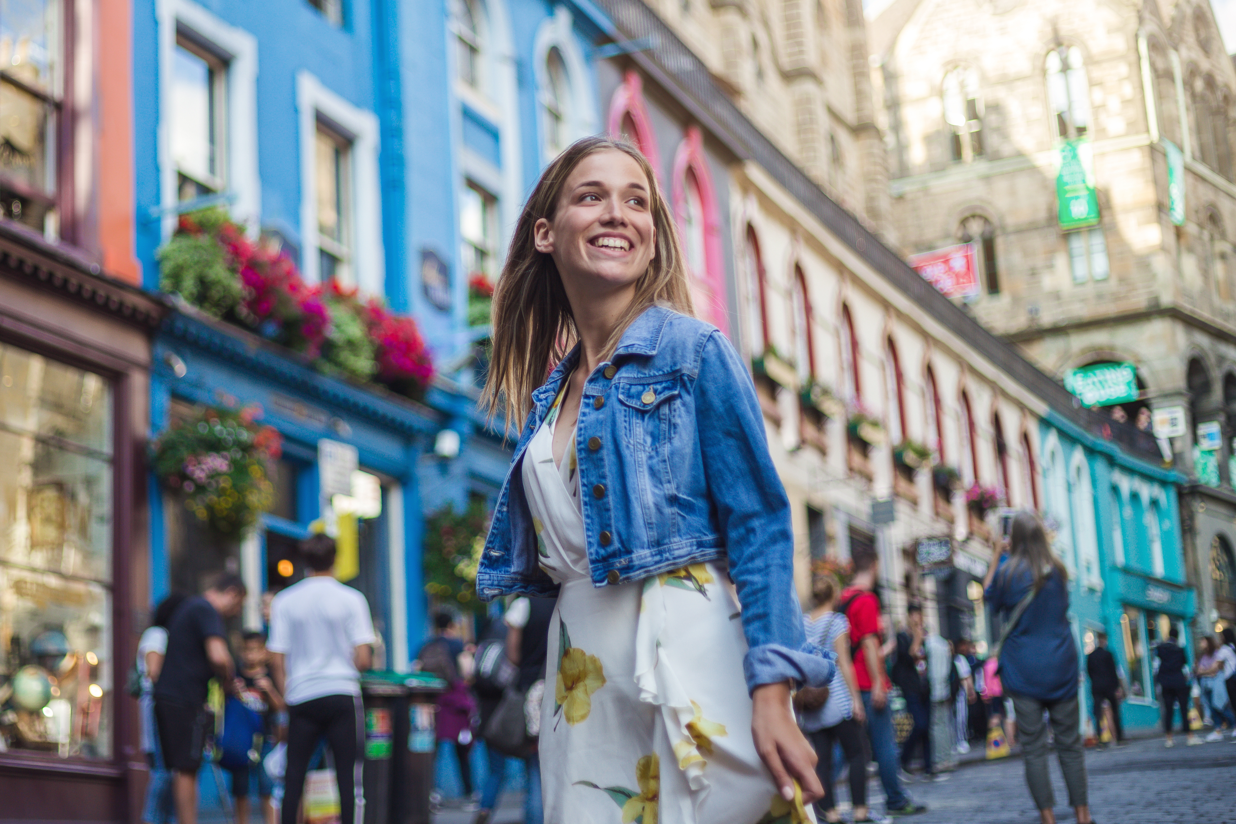Woman smiling while walking down street