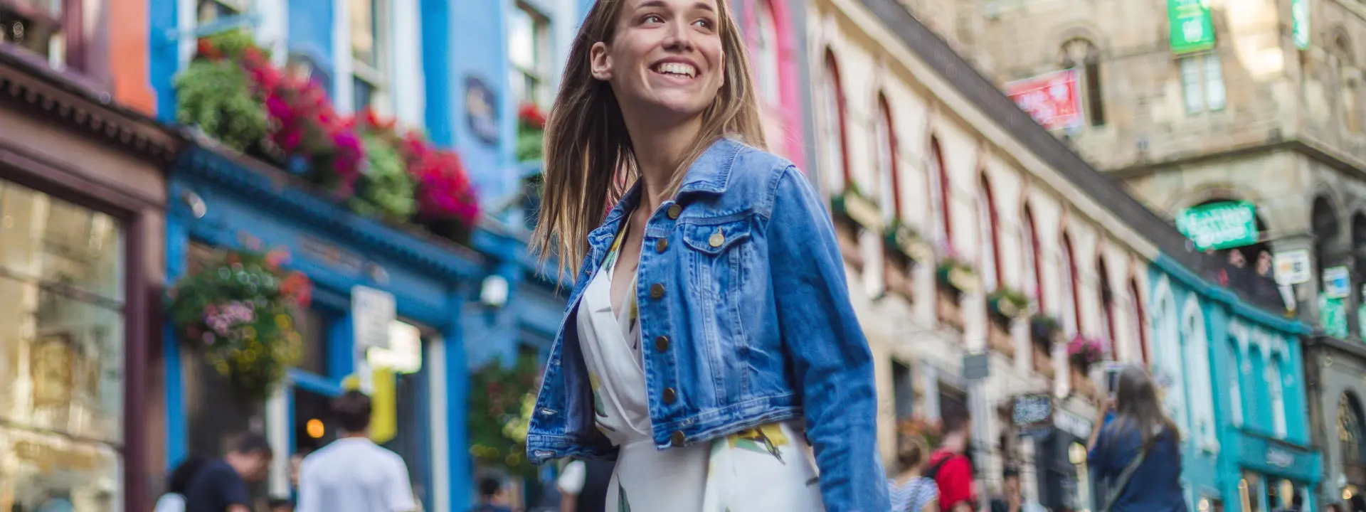 Woman smiling while walking down street