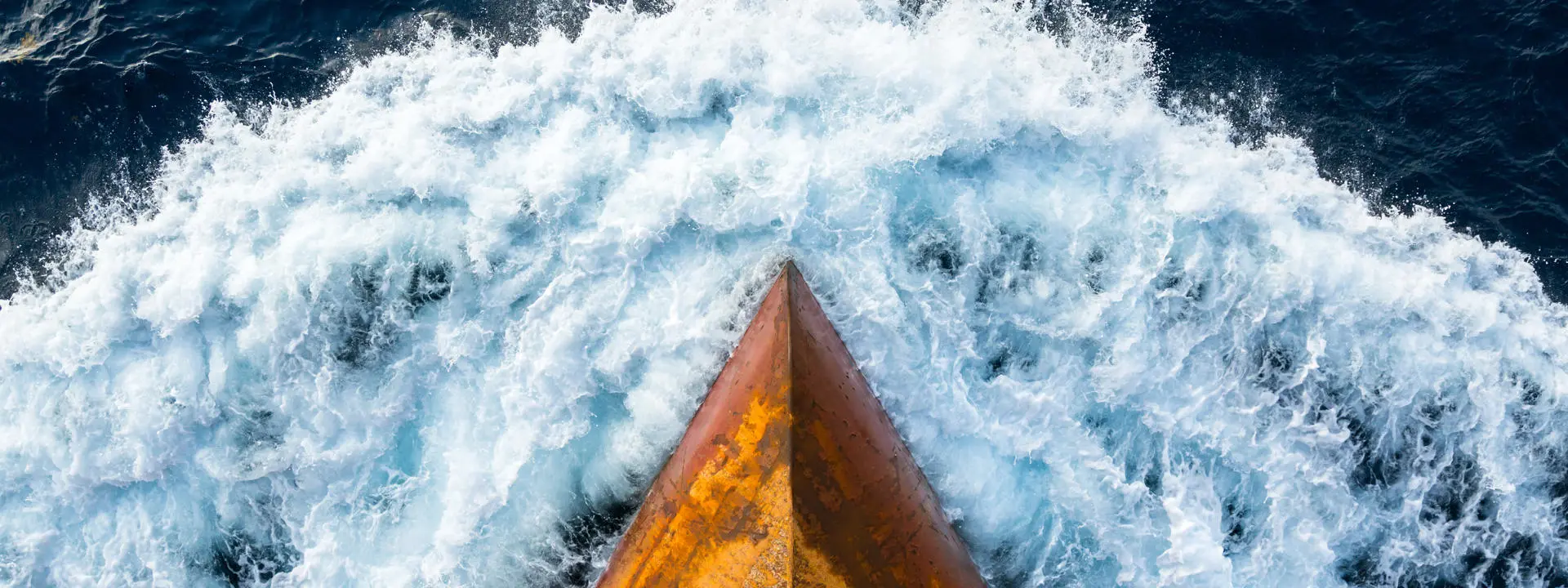 The bow of a ship sailing through water