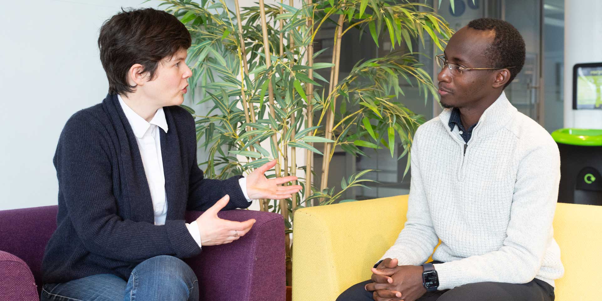 Professor Maïwenn Kersaudy-Kerhoas and Doctoral Researcher Tushabe Vianney engaged in conversation.