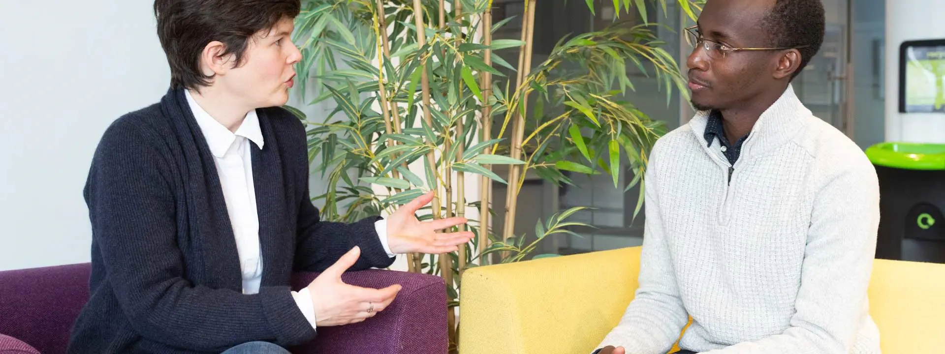 Professor Maïwenn Kersaudy-Kerhoas and Doctoral Researcher Tushabe Vianney engaged in conversation.