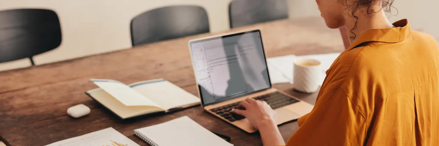 Women works on laptop at home desk