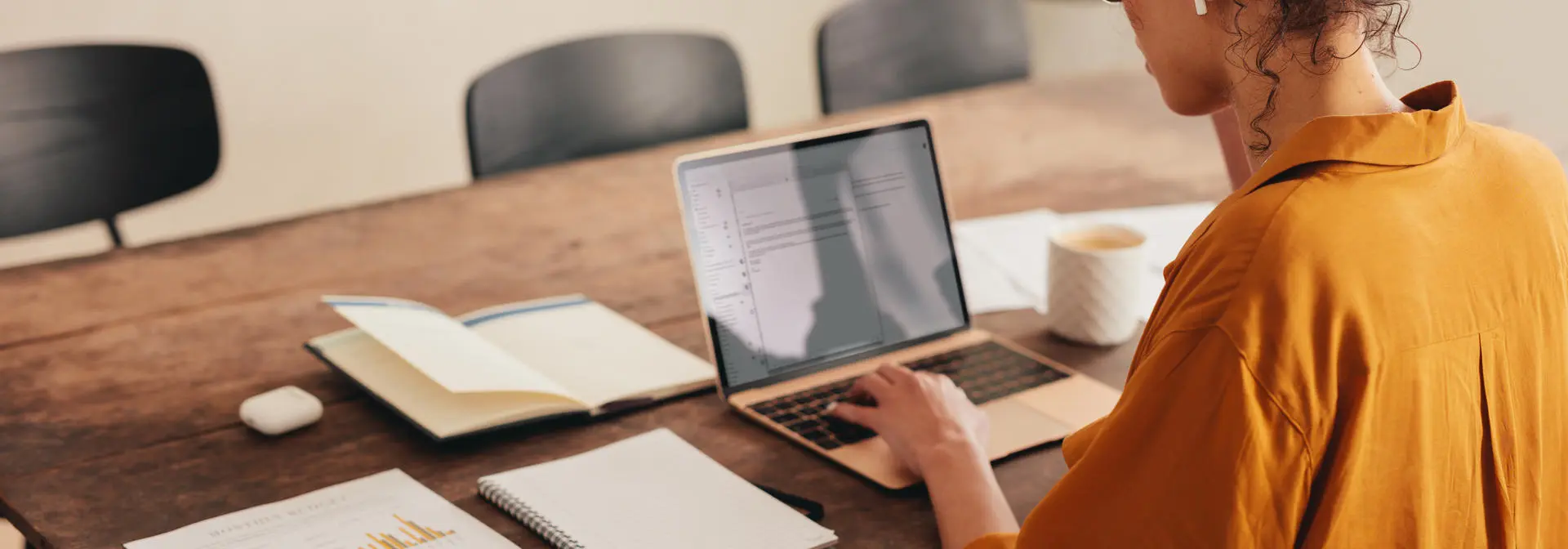 Women works on laptop at home desk