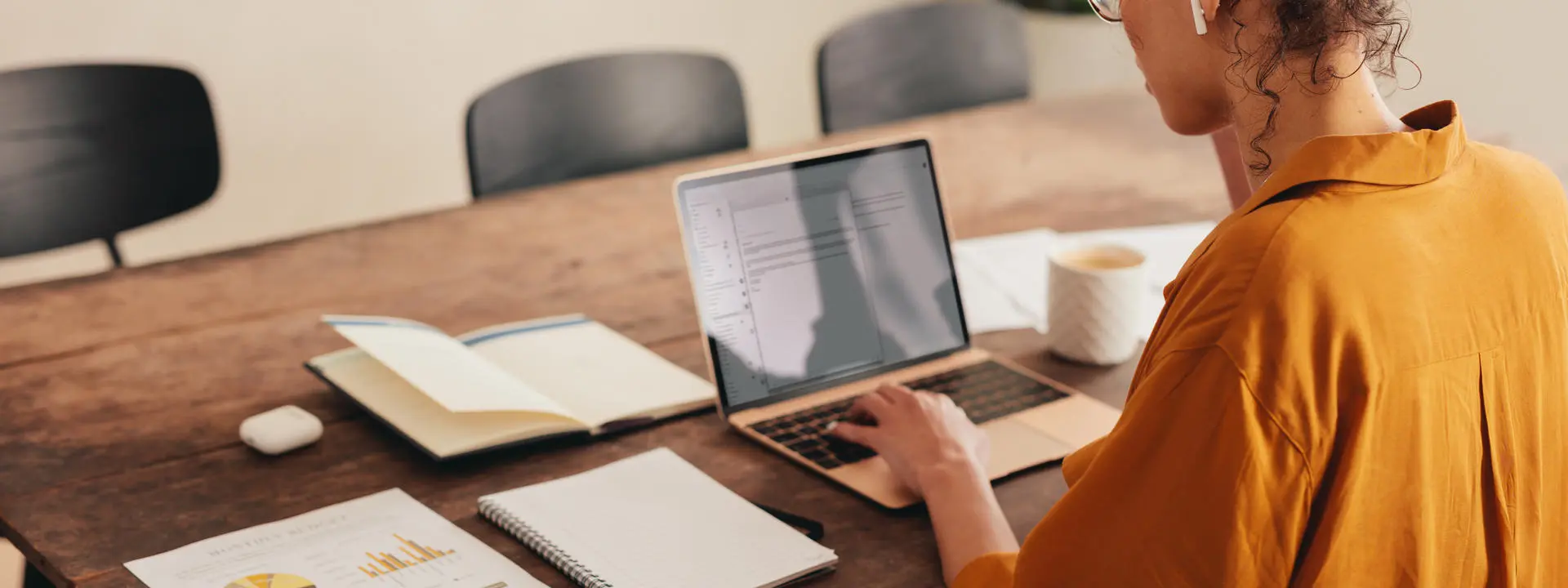 Women works on laptop at home desk