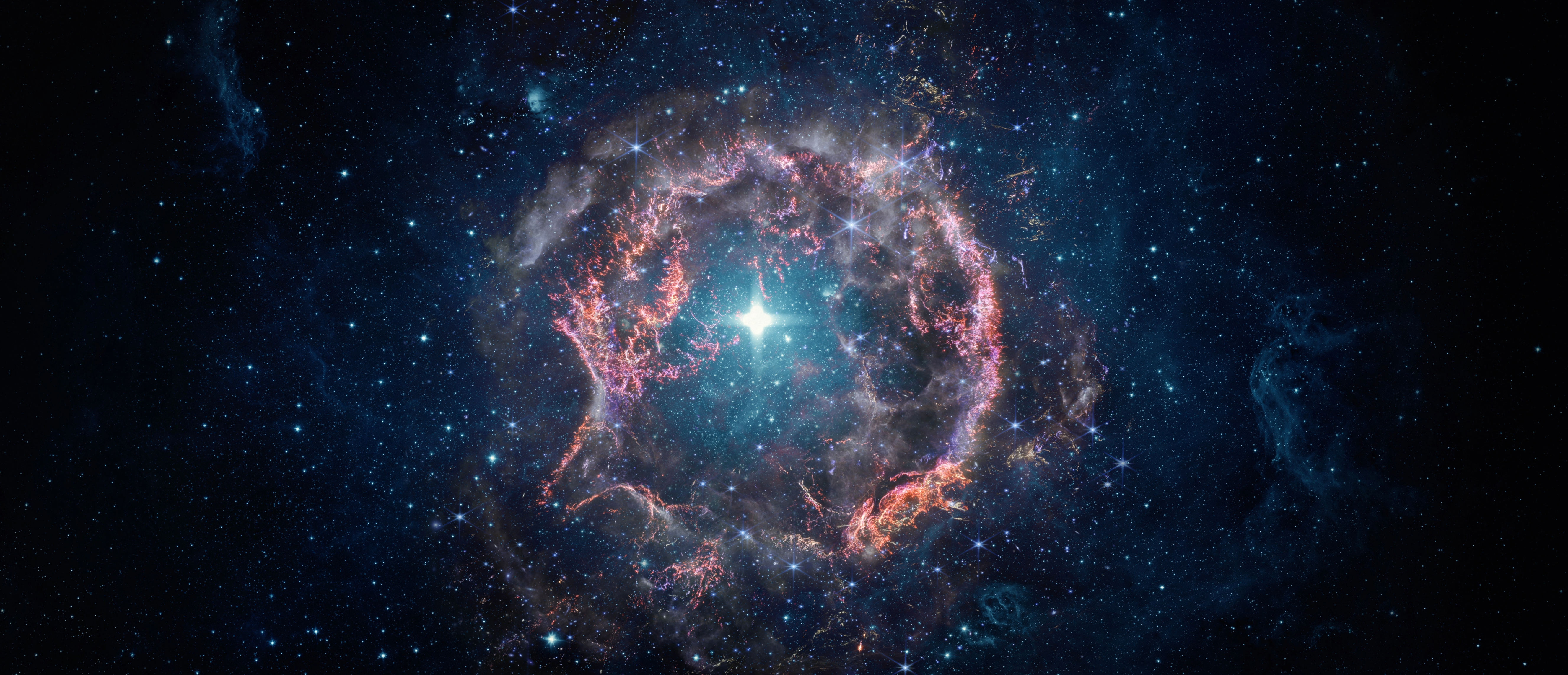 A stunning image of a glowing nebula and bright star surrounded by deep space and scattered stars.