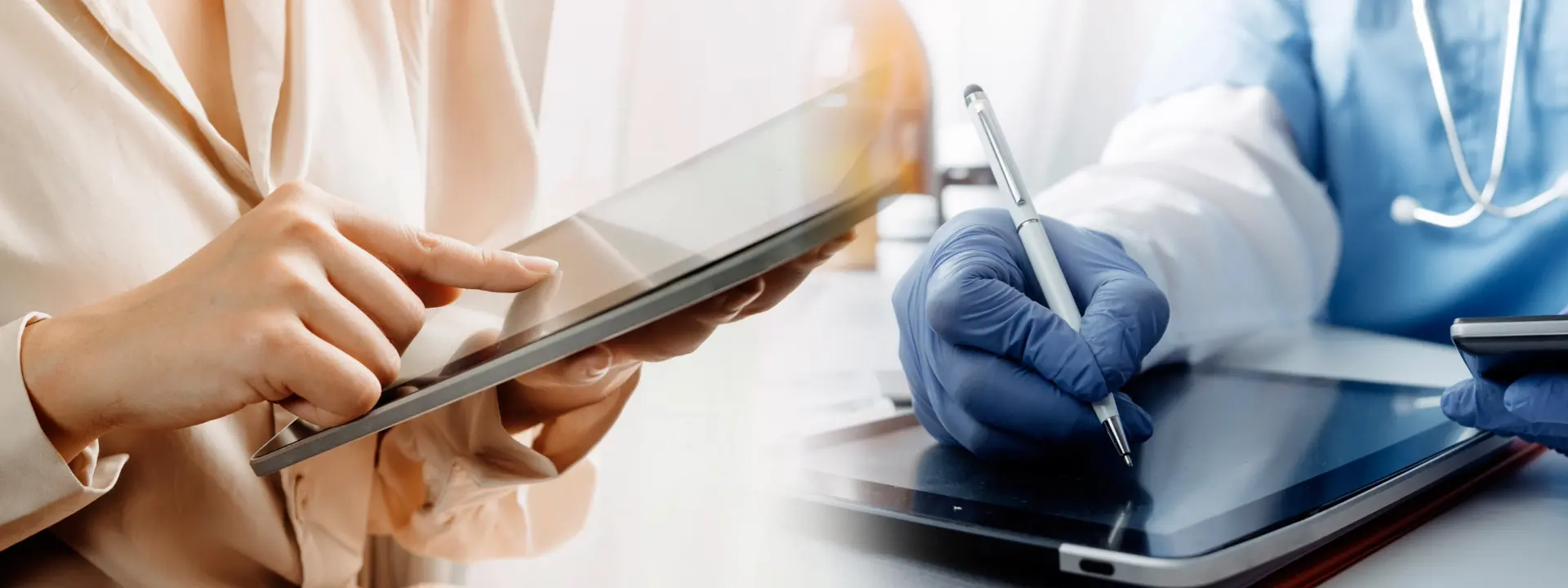 Two people using IPads, one wearing a shirt and one wearing surgical gloves and scrubs.