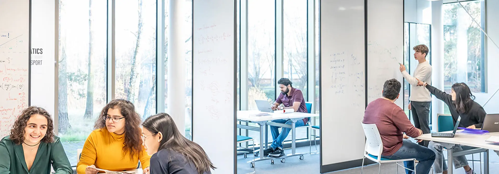 Students sitting at desks studying in groups.