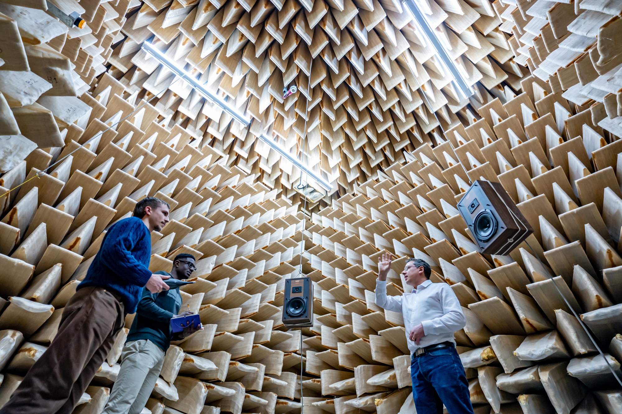 Anechoic chamber with speakers, academic teaching two students 