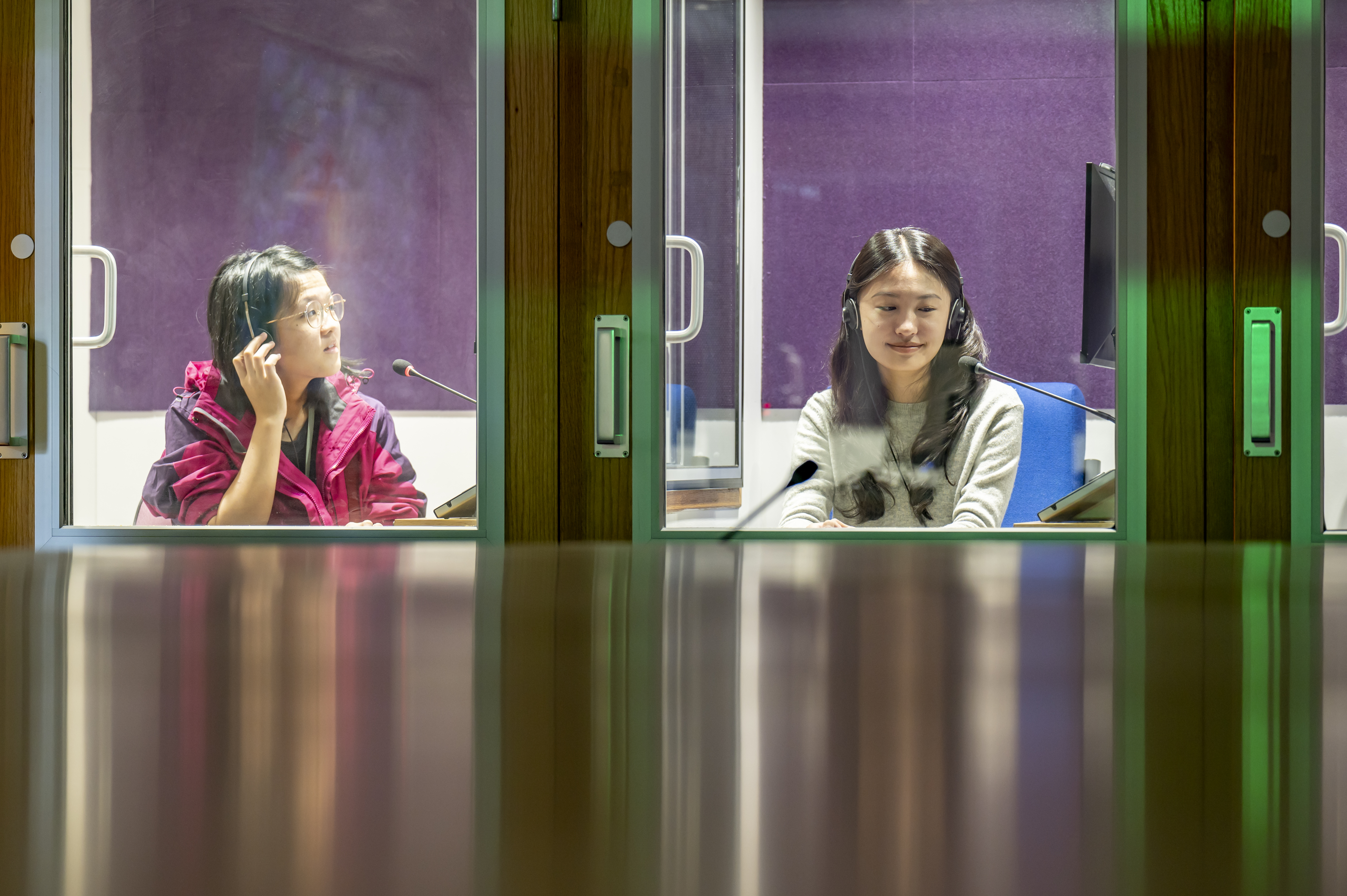 Two female students in interpreting booth