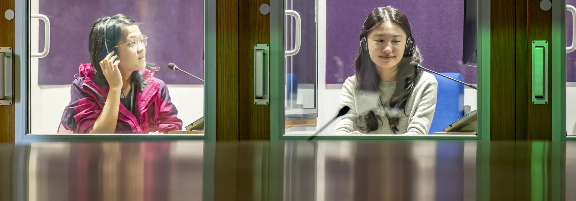Two female students in interpreting booth