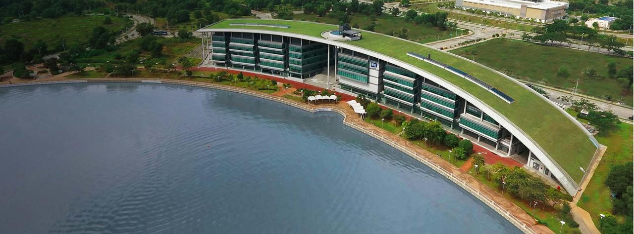 An aerial view of the Malaysia Campus with the lake in the foreground