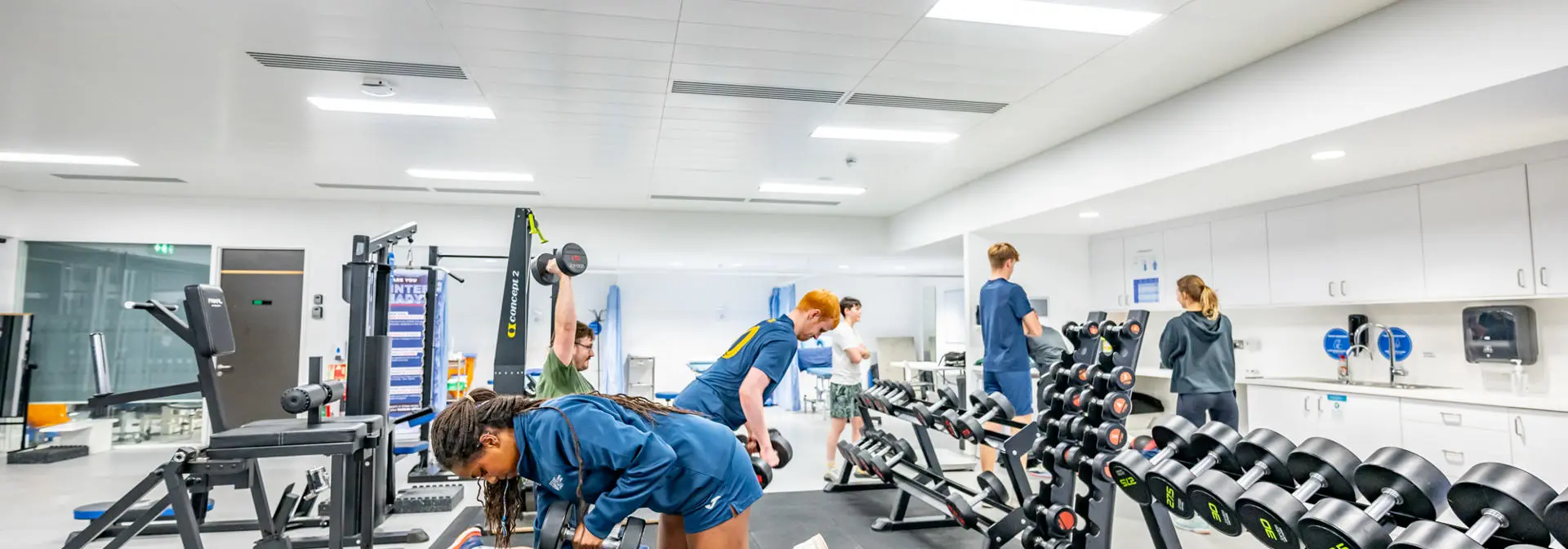 A group of students using weights in the Oriam gymnasium
