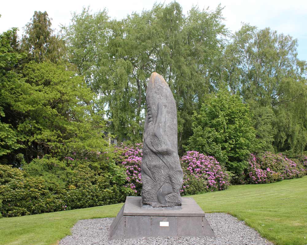 Limestone statue of a whale and calf leaping from the water