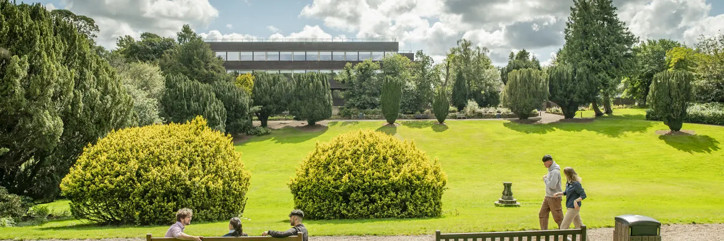 Students seated and walking across the Sunken Garden at the Edinburgh Campus
