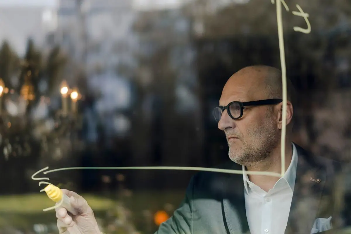 Lecturer writing on clear board