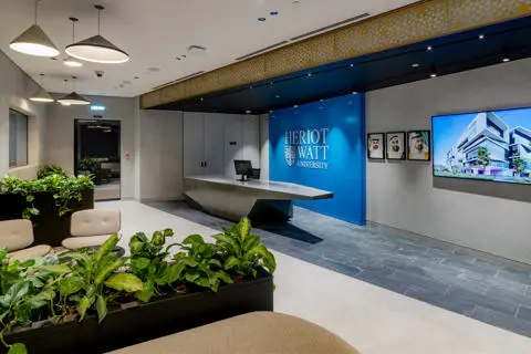 the new James Watt Building lobby featuring indoor plants and a television mounted on the wall