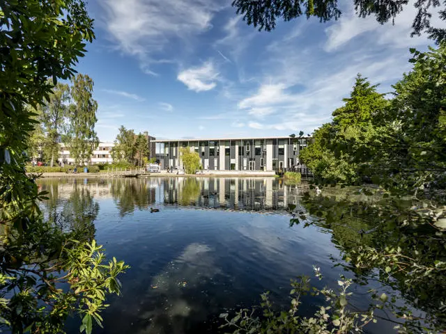 Shot of Heriot-Watt GRID building, with loch in the foreground