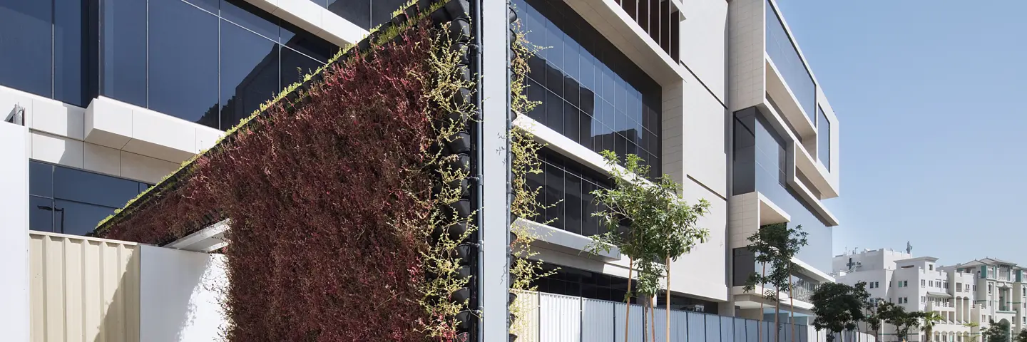 Dubai building exterior wall with plants growing