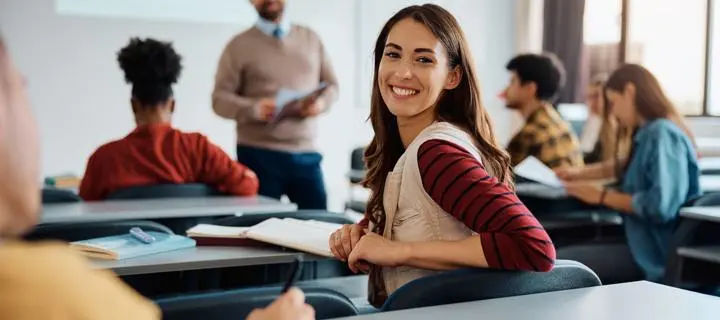 Woman in a class smiling.