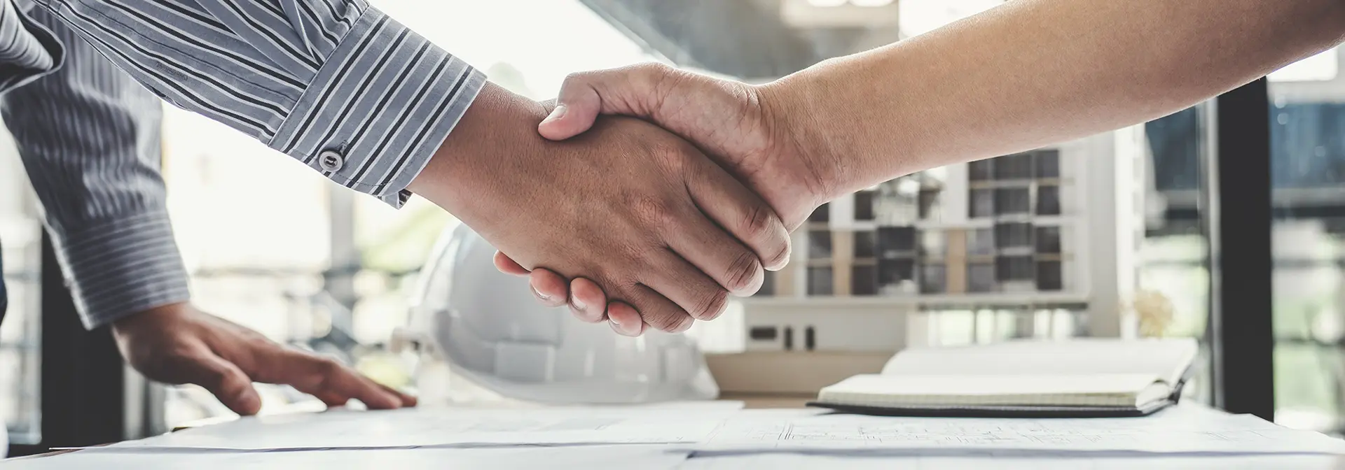 Two workers in industry shaking hands