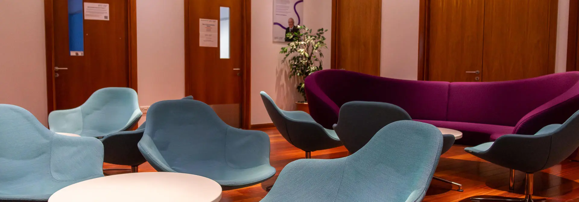 A set of blue chairs arranged neatly in a room.