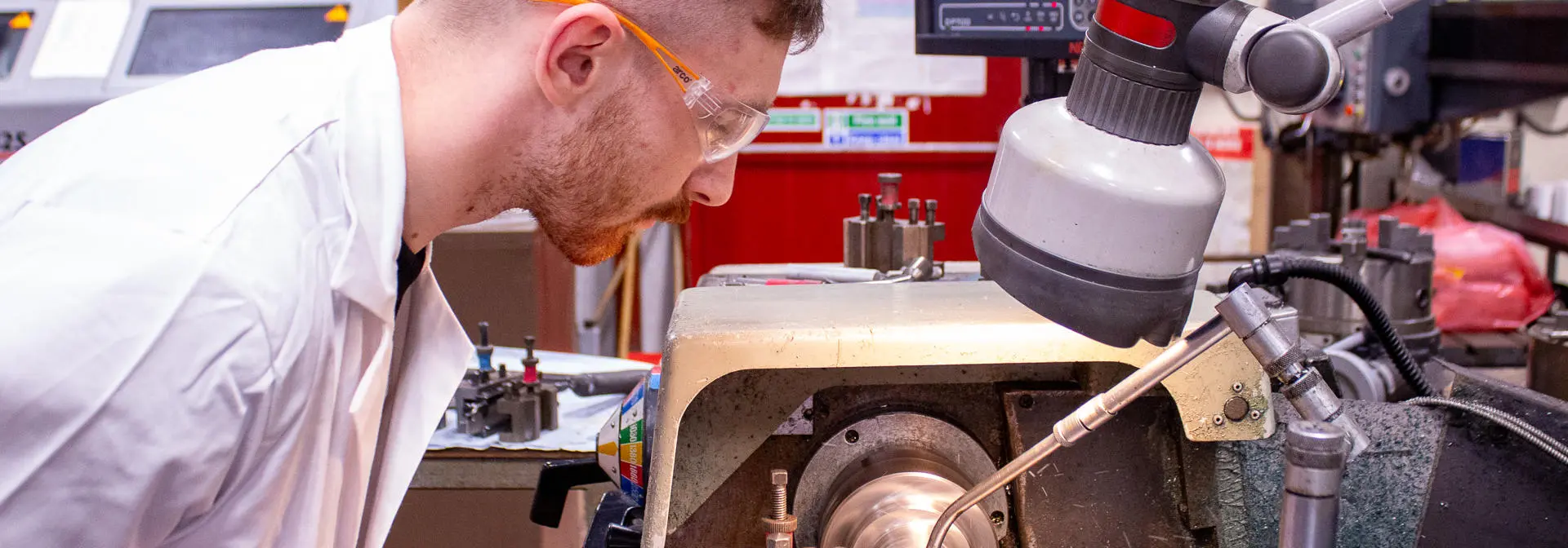 A lab technician using engineering machinery