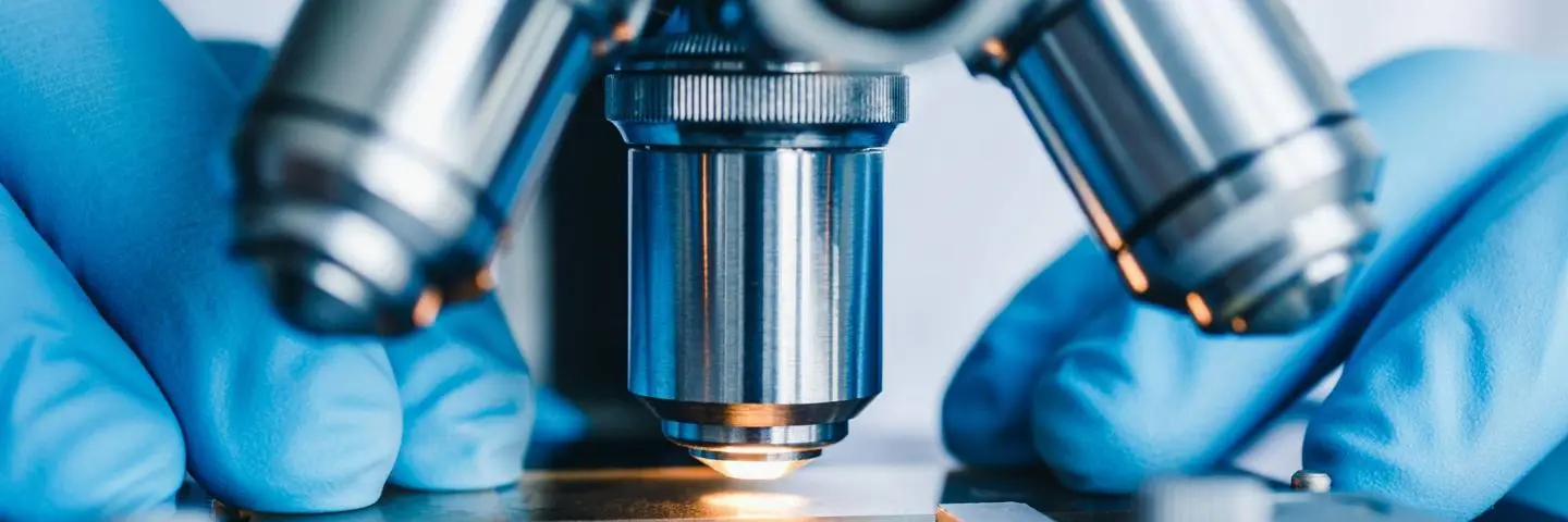 A microscope with a light looking at a slide.